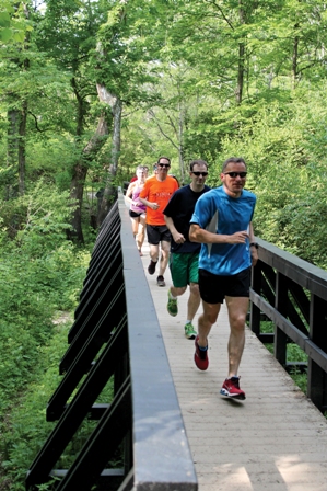 People running on a bridge